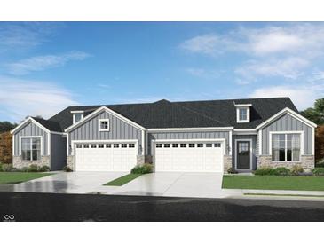 Gray three-car garage home with white accents and landscaping at 1621 Clover Crossing Dr, Greenfield, IN 46140