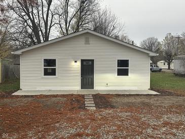 Newly constructed home with white siding, dark gray door, and small front yard at 706 W Franklin St, Thorntown, IN 46071