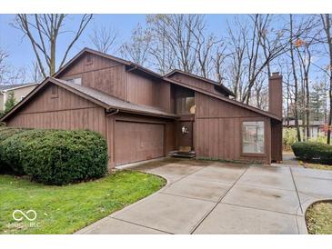 Exterior view of a two-story home with a two-car garage and landscaping at 10592 Lakeshore E Dr, Carmel, IN 46033