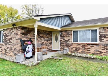 Brick ranch house with a covered porch and well-maintained lawn at 7922 S Sherman Dr, Indianapolis, IN 46237