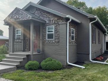 Charming house with gray siding, stone accents, and a welcoming front porch at 306 E Cherry St, Advance, IN 46102