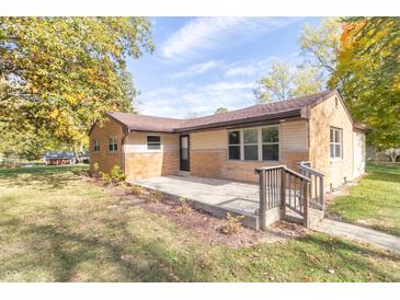 Brick ranch house with a concrete patio and driveway at 408 N Sherwood Dr, Muncie, IN 47304