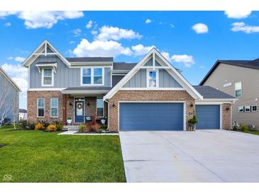 Two-story home with gray and brick exterior, two-car garage, and landscaped lawn at 6427 Nicoson Way, Indianapolis, IN 46259