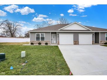 Newly constructed duplex with 2-car garage and landscaped lawn at 1462 Coen Ct, Columbus, IN 47201