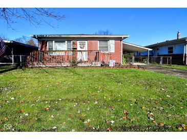 Brick ranch house with carport, deck, and fenced yard at 2628 Walker Ave, Indianapolis, IN 46203