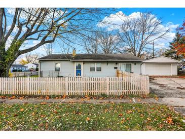 Cute ranch home with a white picket fence and detached garage at 8902 Carla Dr, Indianapolis, IN 46219