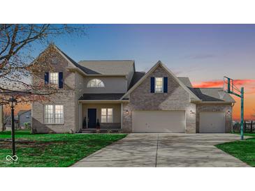 Brick two-story house with a two-car garage and a basketball hoop in the driveway at 10678 Magenta Dr, Noblesville, IN 46060