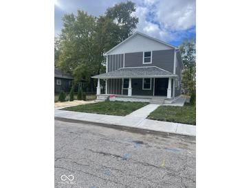 Two-story gray house with white accents, front porch, and landscaped yard at 1826 N Dexter St, Indianapolis, IN 46202