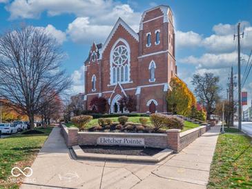 Brick building with arched windows and landscaping at 501 Fletcher Ave # Apt A, Indianapolis, IN 46203