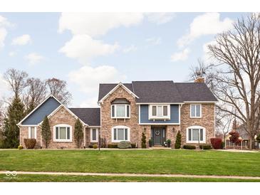 Brick two-story house with a large front yard and mature trees at 6254 Red Alder Dr, Avon, IN 46123