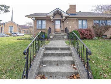 Front entrance of the house with steps and wrought iron railings at 1330 N Bosart Ave, Indianapolis, IN 46201
