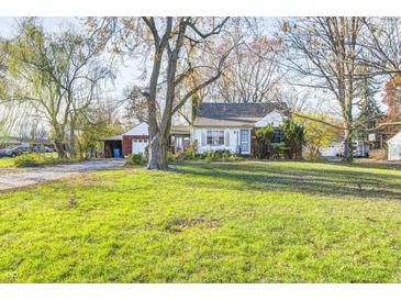 Ranch home with large front yard, mature trees, and detached garage at 80 S Mickley Ave, Indianapolis, IN 46241