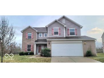 Charming two-story home with a two-car garage and landscaped front yard at 3801 Boundary Bay Dr, Indianapolis, IN 46217