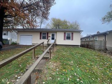 Ranch home with attached garage and landscaped yard at 3407 Harvest Ave, Indianapolis, IN 46226