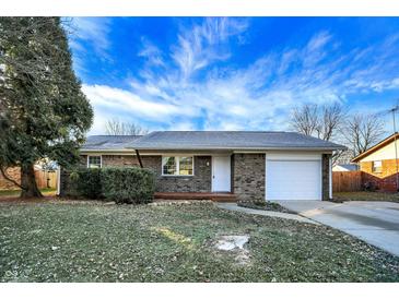 Brick ranch home with attached garage and landscaped lawn at 469 Springdale Dr, Whiteland, IN 46184