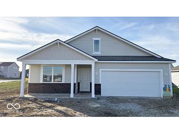 One-story home with gray siding, stone accents, and a two-car garage at 5226 Woodhurst Ln, Indianapolis, IN 46239