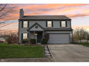 Two-story house with gray siding, green shutters, and a two-car garage at 6 Covington St, Brownsburg, IN 46112