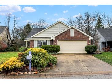 Brick ranch home with attached garage and landscaped front yard at 8627 Champions Dr, Indianapolis, IN 46256