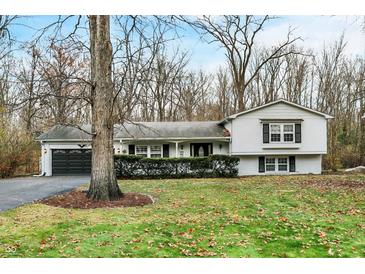 Ranch style home with attached garage and landscaped lawn at 2025 Hamilton Ln, Carmel, IN 46032