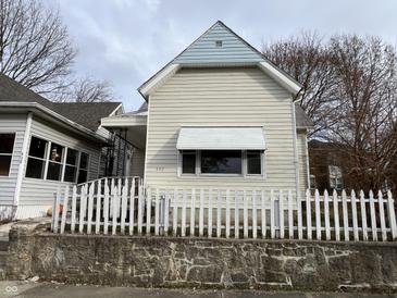 Charming light beige house with a white picket fence at 430 S Proud St, Muncie, IN 47305