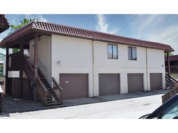 Tan multi-unit building with brown garages and wooden staircases at 2725 Palo Verde Ct, Indianapolis, IN 46227