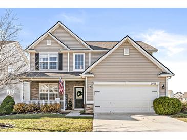 Two-story house with beige siding, a three-car garage, and landscaping at 3466 Limelight, Whitestown, IN 46075