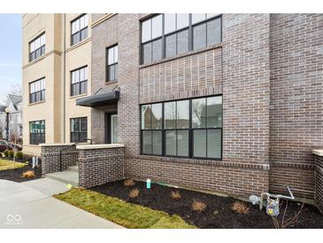 Modern townhome exterior with gray brick, black accents, and a welcoming entrance at 1230 N Alabama St, Indianapolis, IN 46202