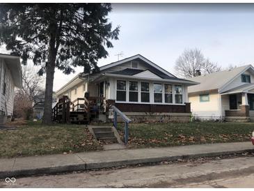 Charming bungalow with sunroom and steps leading to the front entrance at 1324 N Gale St, Indianapolis, IN 46201