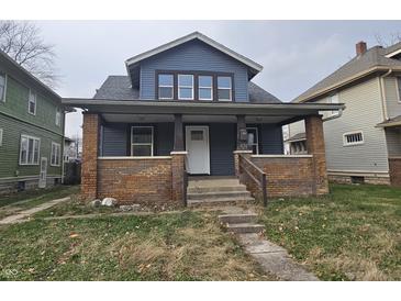 Charming two-story home with brick accents and a covered porch at 424 N Kealing Ave, Indianapolis, IN 46201