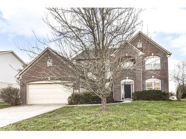 Brick two-story house with attached garage and manicured lawn at 7134 Langham Ct, Indianapolis, IN 46259