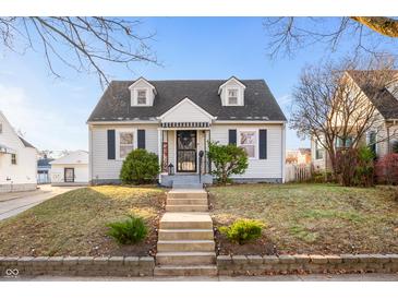 Charming white house with a gray roof, steps, and landscaping at 315 W 37Th St, Anderson, IN 46013