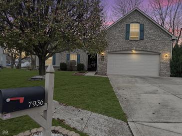 Brick house with two-car garage and well-manicured lawn at 7936 Yucca Ct, Camby, IN 46113