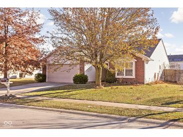 Brick ranch home with attached garage and mature trees at 919 Comb Run Ln, Avon, IN 46123