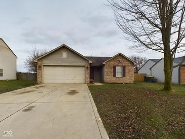 Charming two-story home with a two-car garage and landscaped yard at 6024 Boulder Dr, Anderson, IN 46013