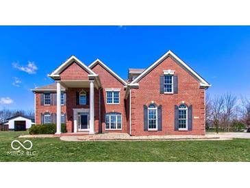 Brick two-story house with a large front yard and attached garage at 4450 W 300 N, Fairland, IN 46126