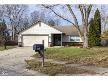 Ranch home with attached garage, mature trees, and a well-maintained lawn at 11560 Cherry Blossom West Dr, Fishers, IN 46038