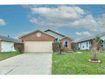 Brick ranch home with attached garage and landscaped lawn at 1678 Farm Meadow Dr, Greenwood, IN 46143