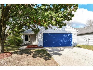 Cute ranch home with a blue garage door and well-manicured lawn at 1854 Keystone Lakes Dr, Indianapolis, IN 46237