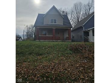 Two-story house with brick and siding, situated on a grassy lot at 1207 W 35Th St, Indianapolis, IN 46208