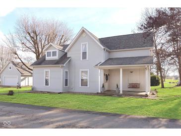 Charming two-story home with a covered front porch and a swing at 330 S Woodward St, Lapel, IN 46051