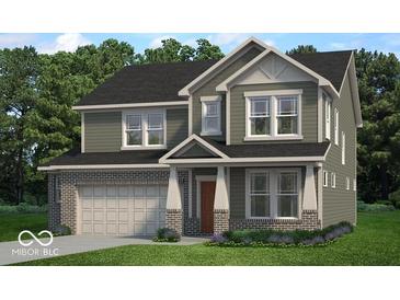 Two-story house with brick and siding exterior, a large garage, and landscaping at 1014 Stonehaven Dr, Indianapolis, IN 46239