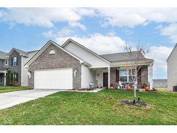 Brick ranch home with attached garage and landscaped lawn at 10837 Jimmy Lake Dr, Indianapolis, IN 46239