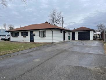 House exterior featuring a ranch-style home with a spacious driveway and detached garage at 1610 Douglas Ln, Lebanon, IN 46052