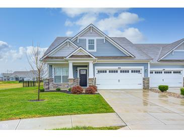 Charming craftsman style home with a two-car garage and landscaped lawn at 4121 Deere Ct, Whitestown, IN 46075