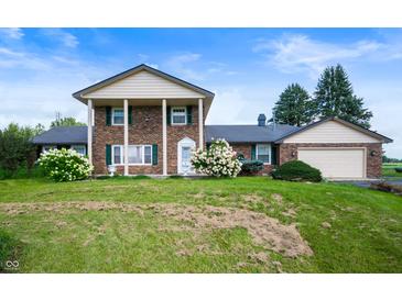 Charming two-story home with a landscaped front yard and attached garage at 4832 E 200 N, Anderson, IN 46012