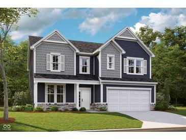 Charming two-story home with a two-car garage and landscaped yard at 67 Sterling Pl, New Whiteland, IN 46184