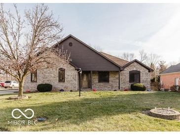 Charming two-story home with a landscaped front yard and a welcoming entryway at 7665 Stones River Ct, Indianapolis, IN 46259