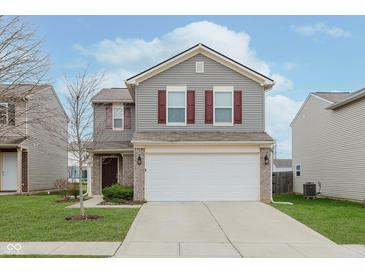 Two-story house with gray siding, burgundy shutters, and a white garage door at 4086 Lassen Ln, Indianapolis, IN 46235