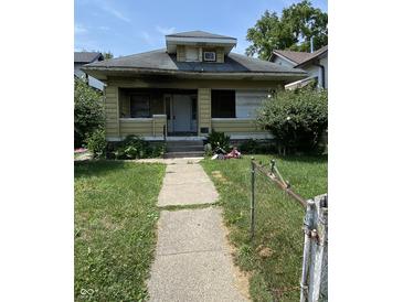 One-story home with a covered front porch and a walkway leading to the entrance at 802 N Oakland Ave, Indianapolis, IN 46201