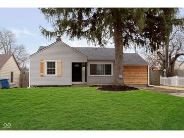 Charming single-story home with a lush green lawn and updated exterior at 5615 Brouse Ave, Indianapolis, IN 46220